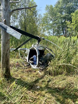 Crashed helicopter in wooded area.