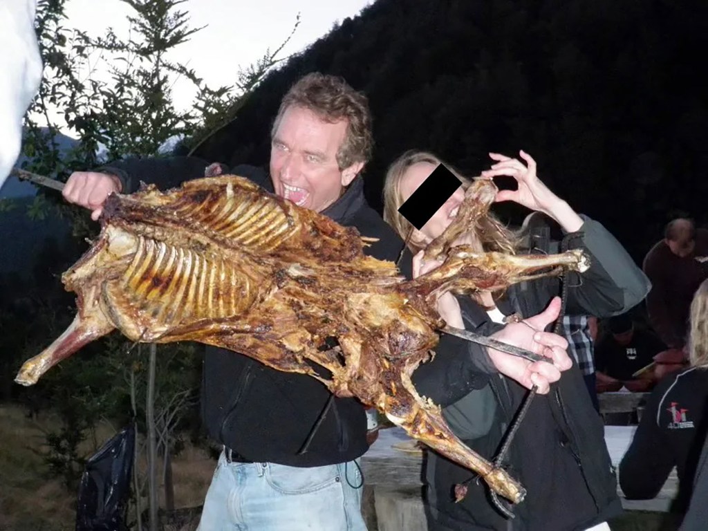 Robert F. Kennedy Jr. (left) poses what what appears to be a barbecued dog carcass.