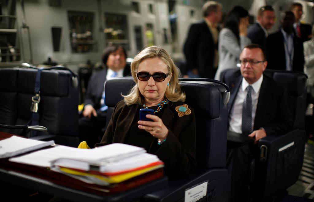 Hillary Clinton sunglasses meme - she's holding a cellphone.