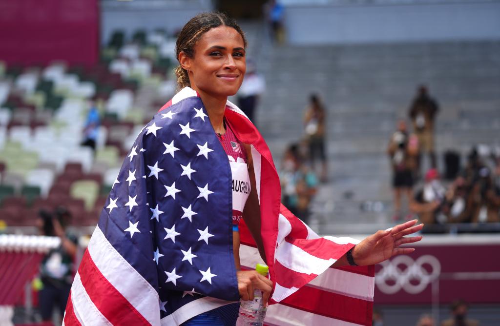 Sydney McLaughlin of the United States wrapped in a flag, celebrating her win in the Women's 400m Hurdles final at the Tokyo 2020 Olympics