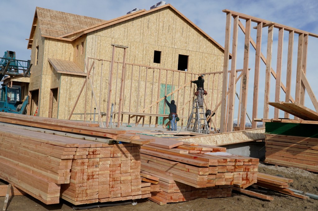 Piles of lumber on the construction site of a single family home in Lehi, Utah