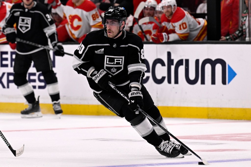 Los Angeles Kings center Pierre-Luc Dubois controls the puck against the Calgary Flames during the first period of an NHL hockey game in Los Angeles, Dec. 23, 2023. 