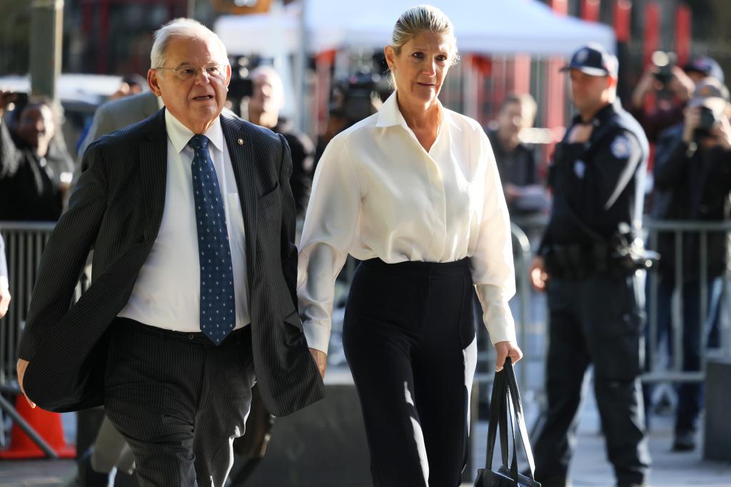 Robert Menendez and Nadine Menendez walk holding hands outside federal court in Manhattan.