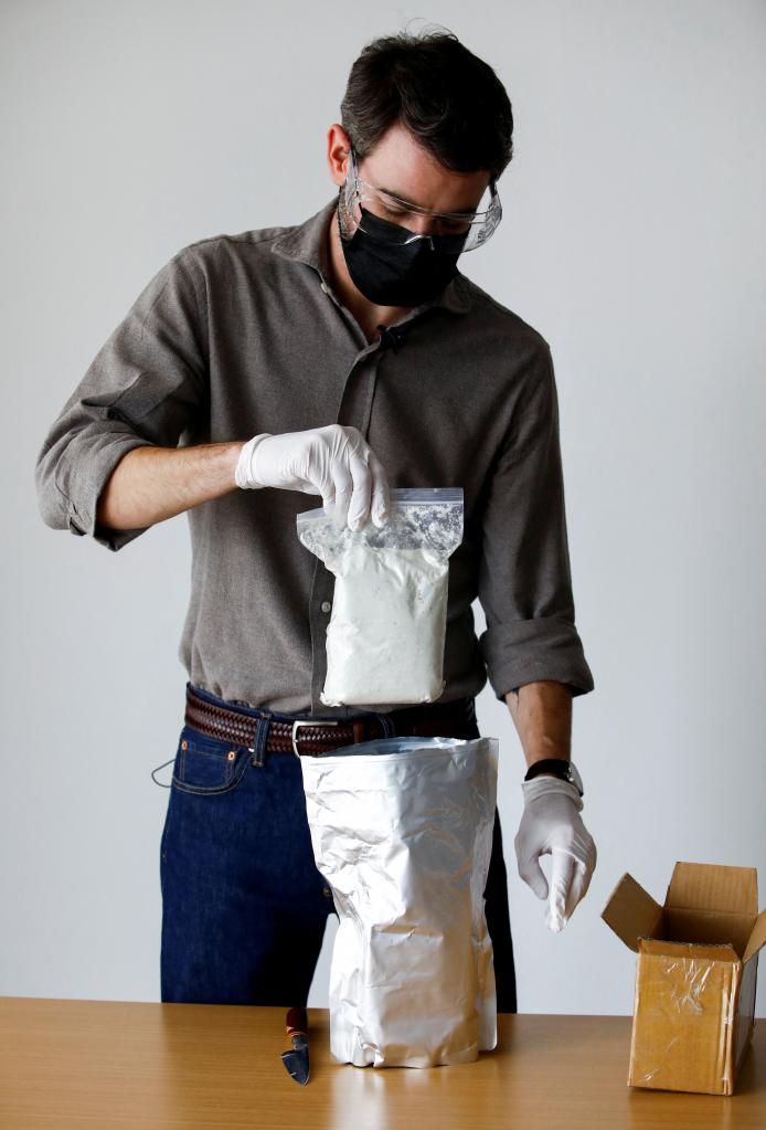 Reuters journalist Stephen Eisenhammer unboxes fentanyl precursors at Reuters' office, in Mexico City, Mexico, October 4, 2023