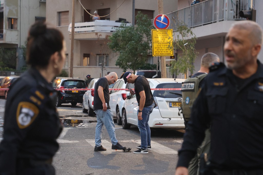 Israeli policemen search the scene where an explosion took place in Tel Aviv Friday.