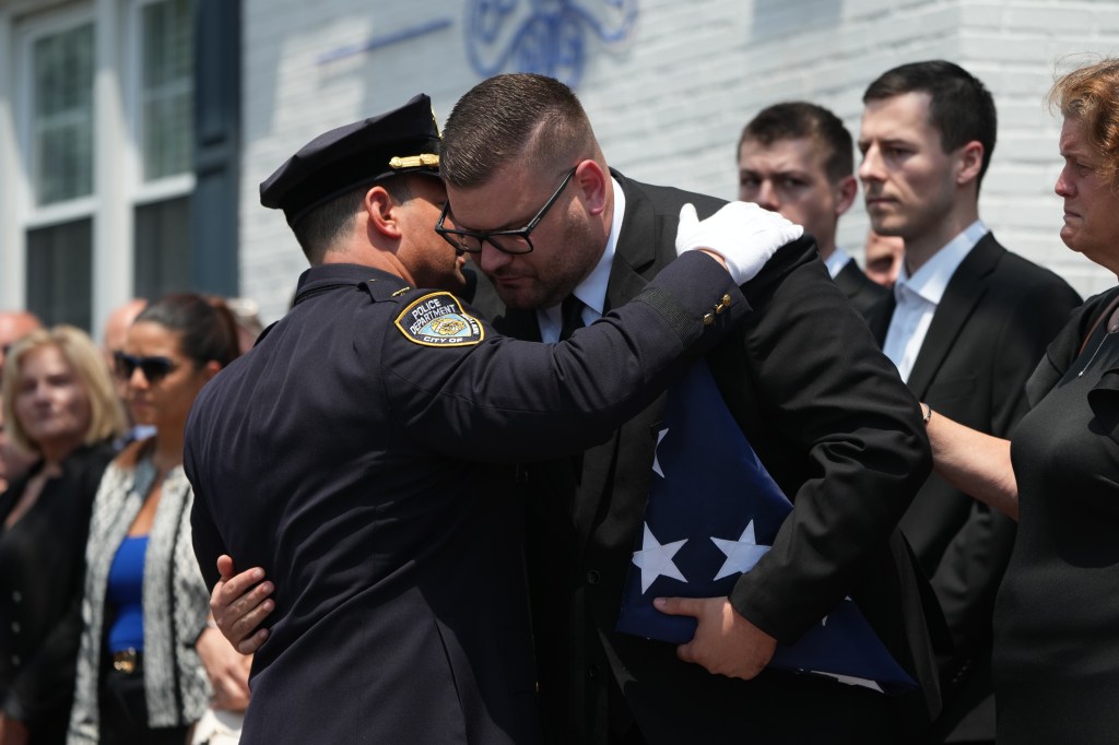 Husband receives folded up flag that was on his dead wife's casket.