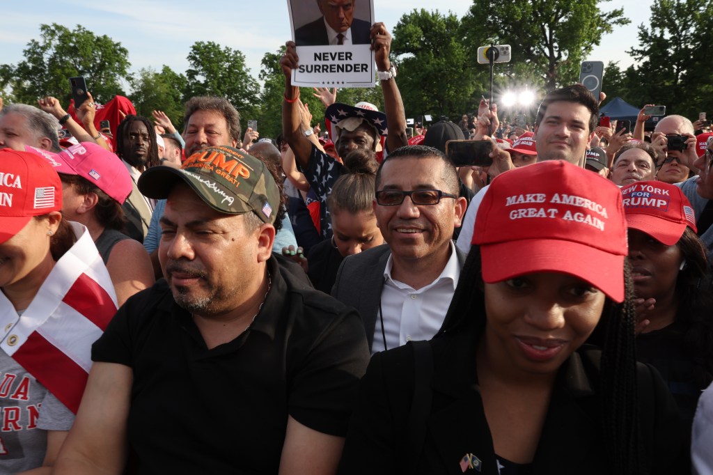 Supporters of former President Donald Trump watch as he holds a rally in the historical Democratic district of the South Bronx on May 23, 2024 in New York City