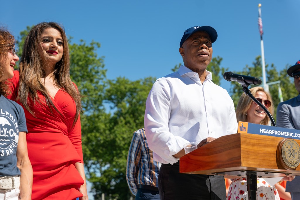 Mayor Eric Adams speaks at the Astoria Pool with Jenifer Rajkumar by his side on the opening day of New York City's public swimming pools in the borough of Queens on June 27, 2024. 