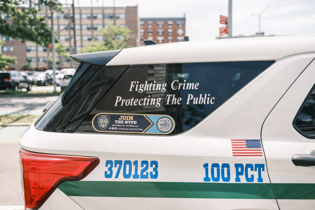 A new NYPD vehicle with their updated motto is seen outside the 100th Precinct Wednesday