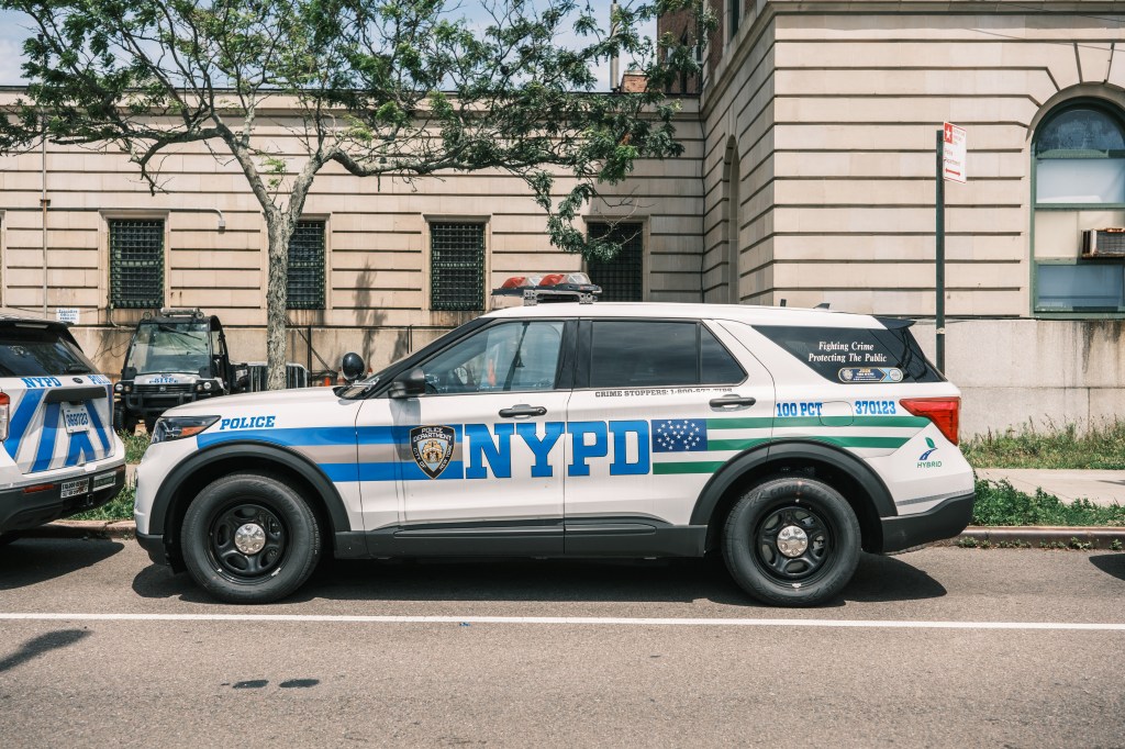 A new NYPD vehicle with their updated motto is seen outside the 100th Precinct Wednesday