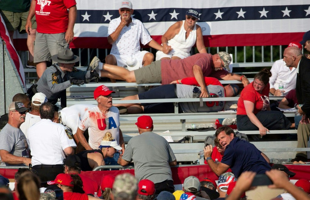 Trump supporters covered in blood after the shooting.