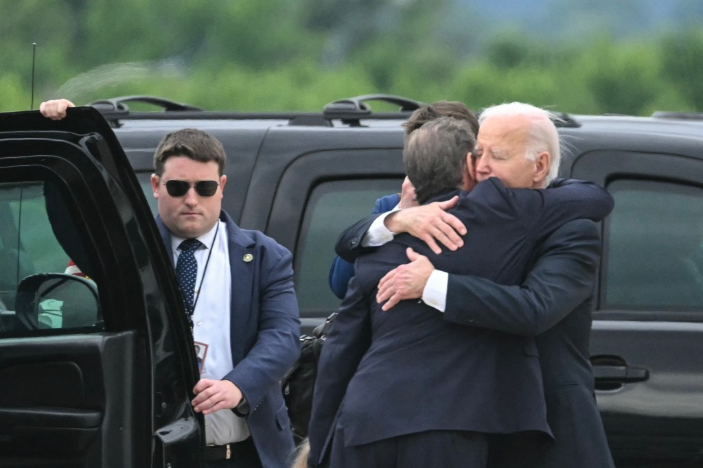 US President Joe Biden hugging his son Hunter Biden at Delaware Air National Guard Base on June 11, 2024