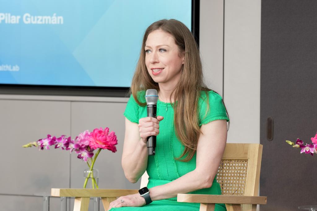 Chelsea Clinton in a green dress speaking onstage at the Inaugural Health Lab hosted by Women's Health at Hearst Tower, New York City