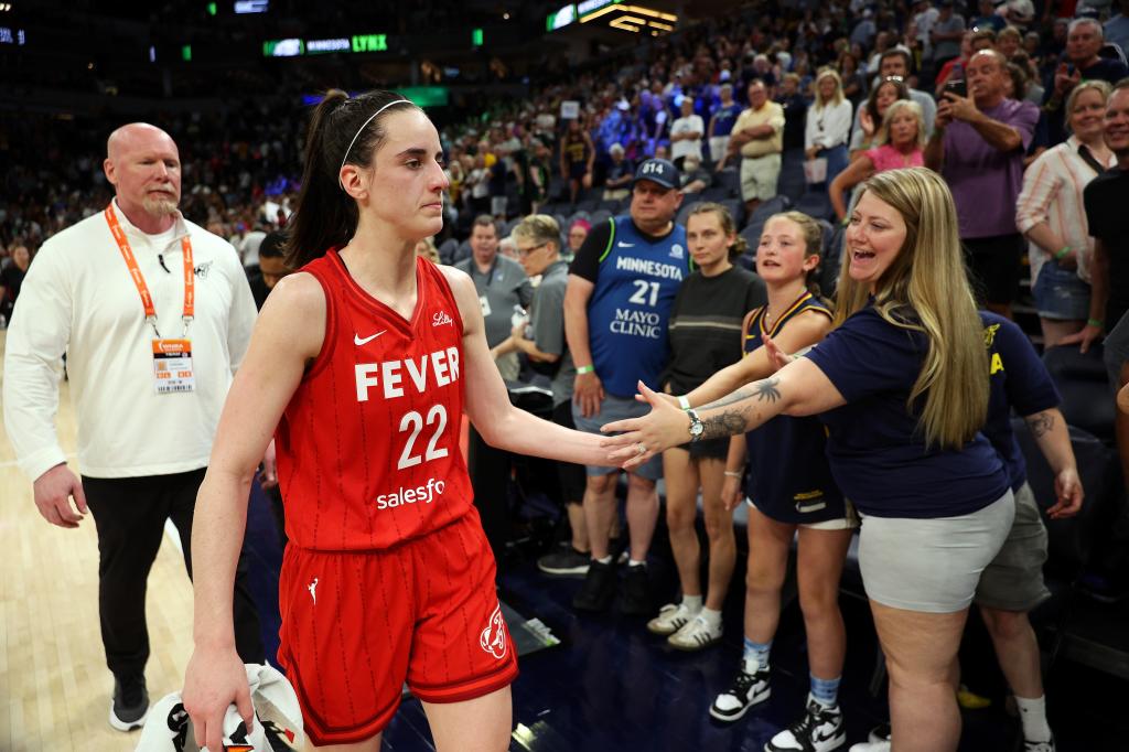 Caitlin Clark #22 of the Indiana Fever interacts with fans after the game against the Minnesota Lynx at Target Center on July 14, 2024 in Minneapolis, Minnesota. The Fever defeated the Lynx 81-74.