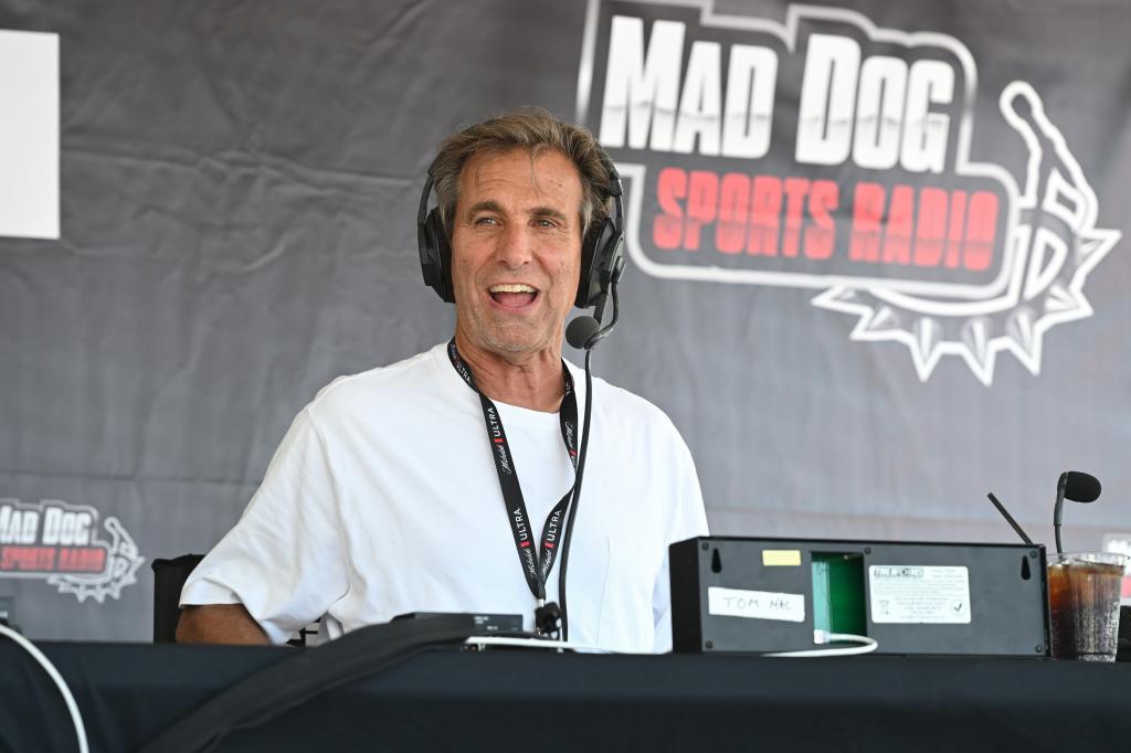 Chris 'Mad Dog' Russo speaking into a microphone during a SiriusXM broadcast at Bar A in Lake Como, New Jersey