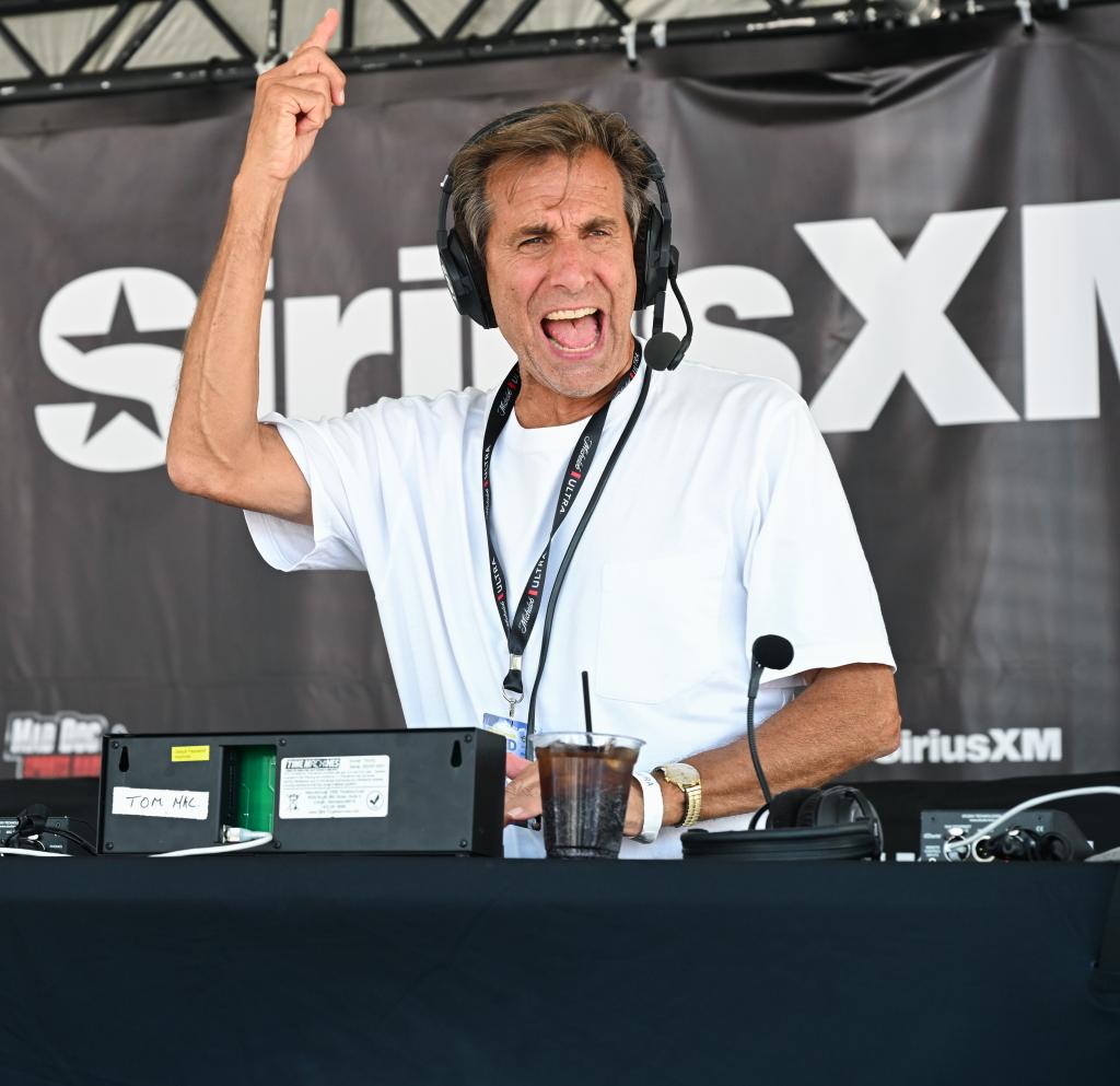 Chris 'Mad Dog' Russo wearing headphones, speaking at SiriusXM broadcast, and gesturing with his finger at Bar A in Lake Como, New Jersey