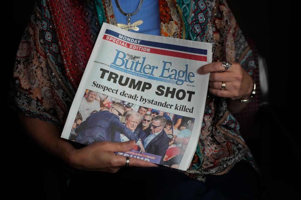 The front cover of the Butler Eagle newspaper holding up a special edition of the paper published after former President Donald Trump was shot at a rally in Butler on July 13, 2024.