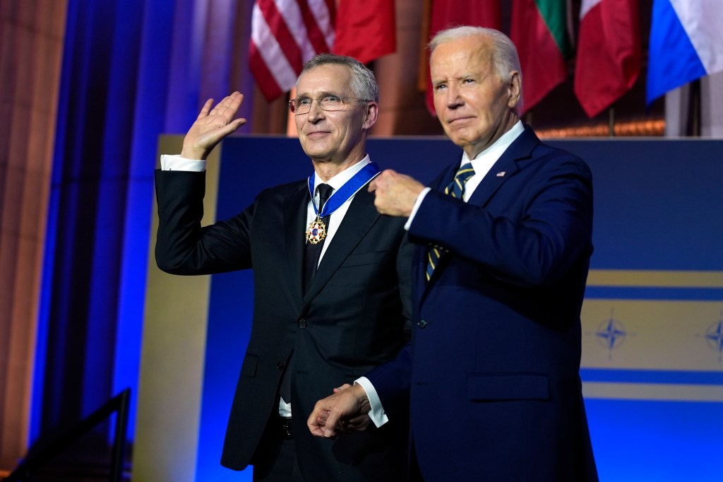 President Joe Biden, right, presents NATO Secretary General Jens Stoltenberg with the Presidential Medal of Freedom on the 75th anniversary of NATO.