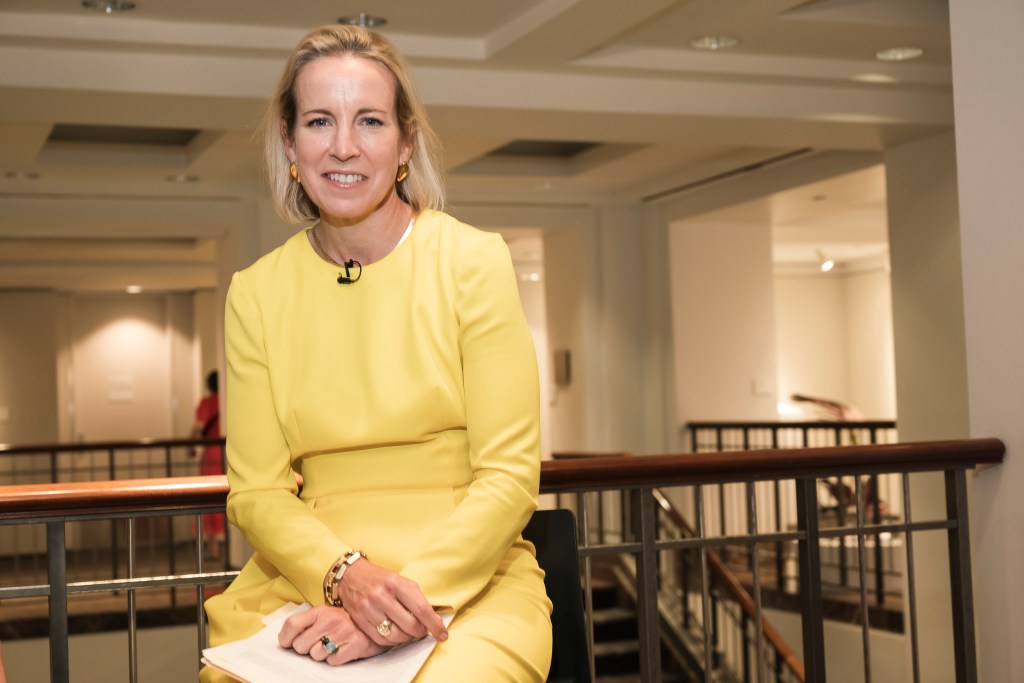 Bonnie Brennan, President of Americas at Christie's auction house, wearing a yellow dress at 20 Rockefeller Plaza, Manhattan NY