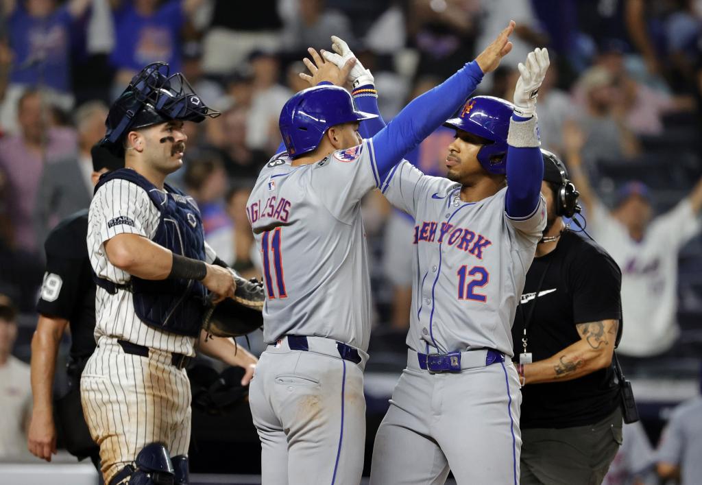 Francisco Lindor (right) celebrates with Jose Iglesias after belting a three run homer in the eighth inning, his second of the game in the Mets' blowout win.