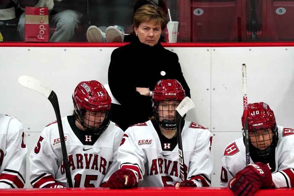 Harvard Crimson head coach Katey Stone behind the bench as Harvard hosts R.P.I. at the Bright-Landry Hockey Center. 