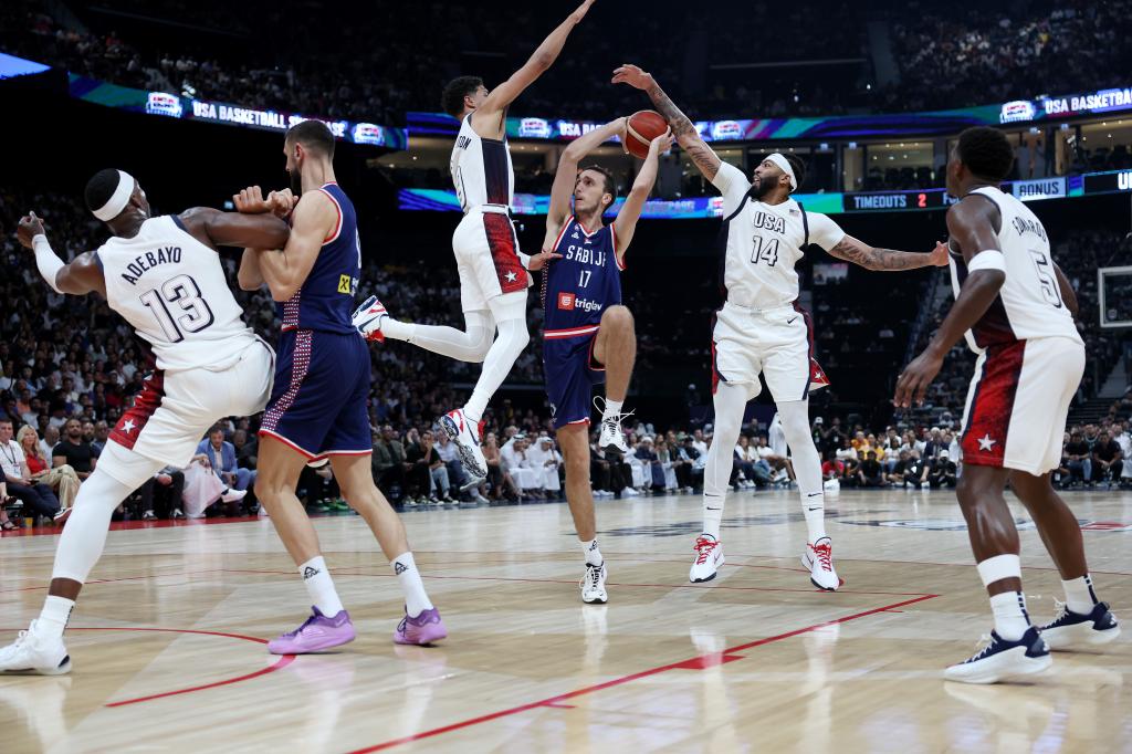 Aleksej Pokusevski #17 of Serbia shoots while guarded by Tyrese Haliburton (3rd L) #9 and Anthony Davis (2nd R) #14 of the United States during the second half of an exhibition game between the United States and Serbia ahead of the Paris Olympic Games at Etihad Arena on July 17, 2024 in Abu Dhabi, United Arab Emirates. 