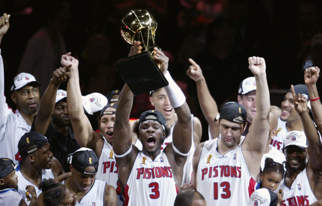 Ben Wallace #3 (C) of the Detroit Pistons holds up the Larry O'Brien NBA Championship trophy as he celebrates with teammatesafter defeating the Los Angeles Lakers 100-87 in game five of the 2004 NBA Finals on June 15, 2004 at The Palace of Auburn Hills in Auburn Hills, Michigan. 