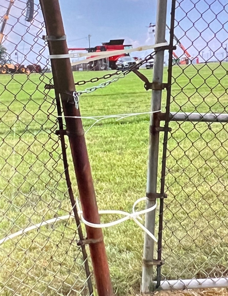 Photo of zip tied gates, on edge of Butler County Farm Show Property.