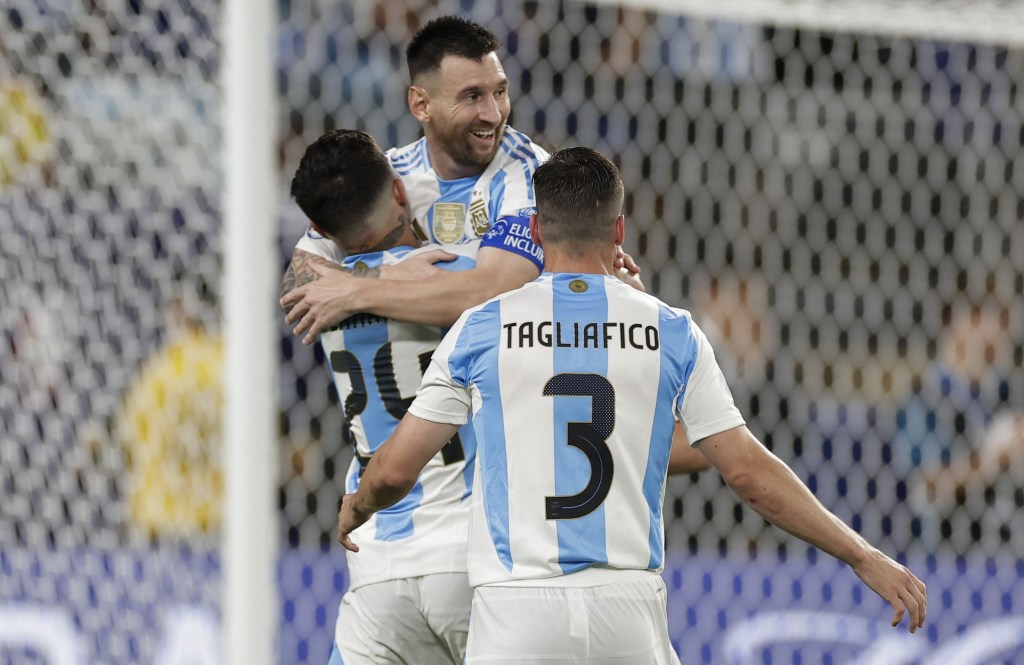 Lionel Messi gets hugged by teammates after scoring a goal in the second half of Argentina's 2-0 Copa America semifinal win over Canada.