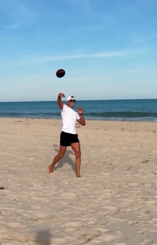 Tom Brady playing football on a beach in the Hamptons