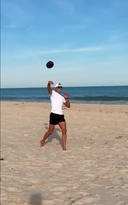 Tom Brady playing football on the beach in the Hamptons