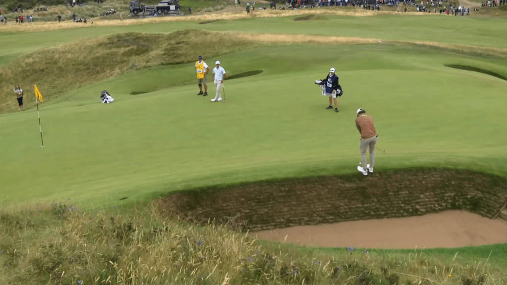 Cameron Young swings a tough chip shot at the British Open on the eighth hole.