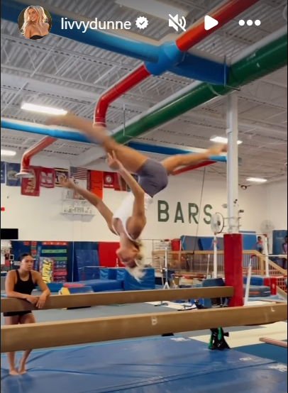 A woman jumping on parallel bars