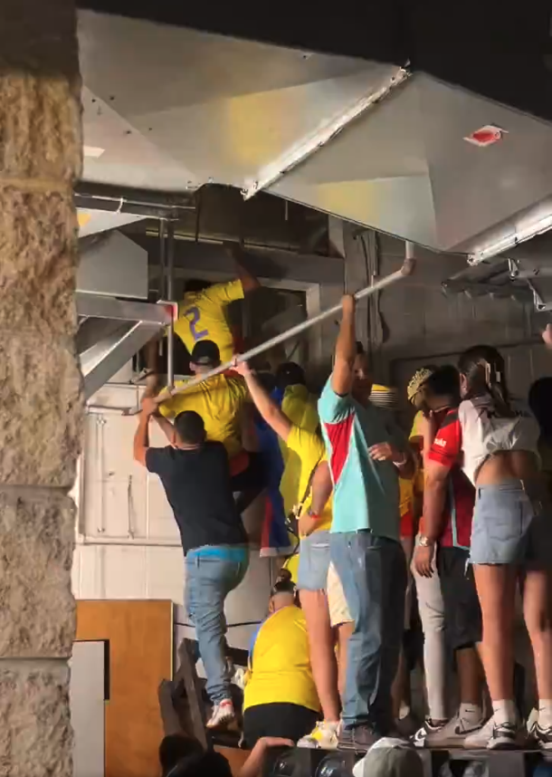 Fans climb through air vents to get into the Hard Rock Stadium in Miami. 