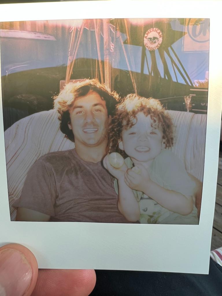 A California father, Harrison Tinsley, sitting with his son Sawyer on a chair after winning a custody battle