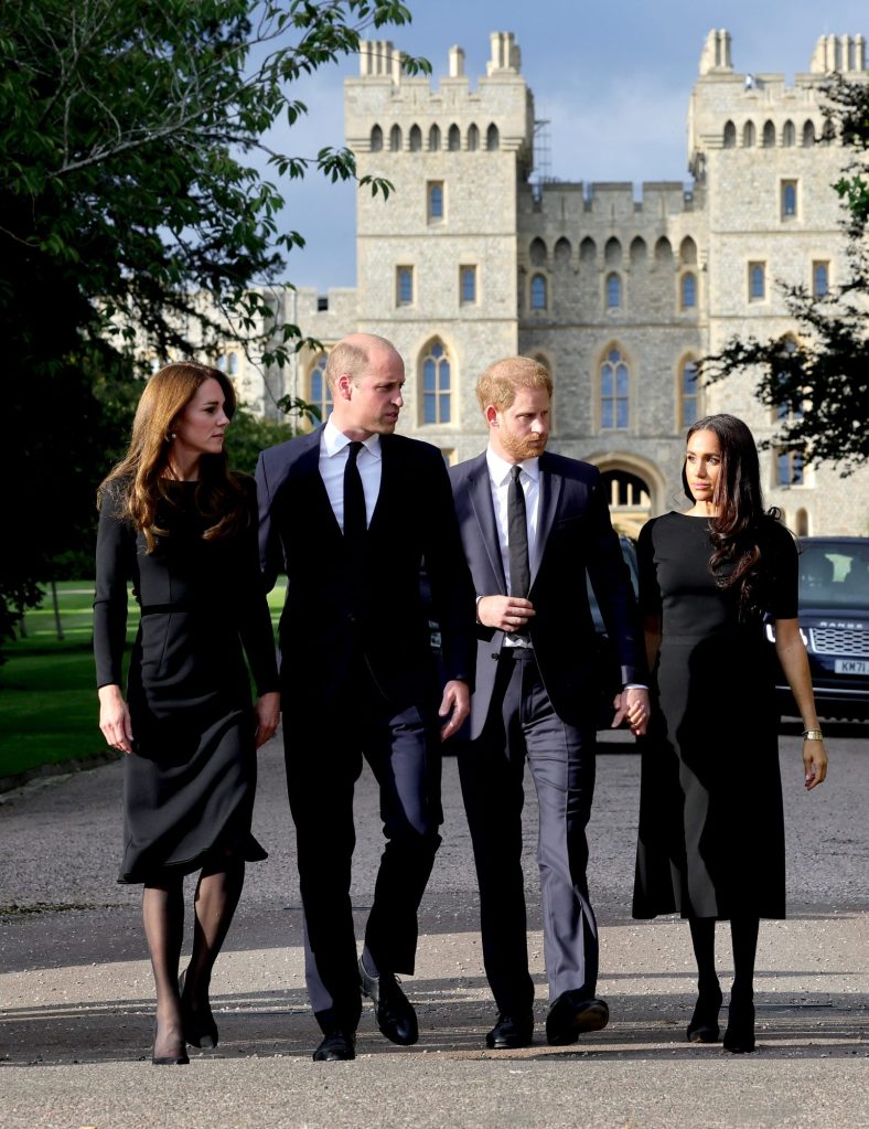 Prince William, Prince Harry, Meghan Markle, and Catherine, Princess of Wales walking in front of Windsor Castle amid wellwishers
