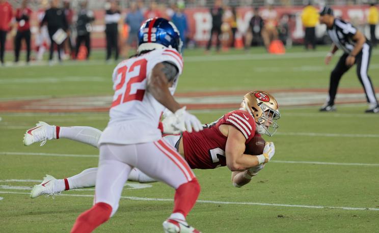 Christian McCaffrey #23 of the San Francisco 49ers completes a reception for a first down.