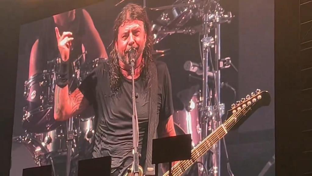 Dave Grohl singing into a microphone at the Foo Fighters concert at Citi Field, abruptly cut short due to a storm.