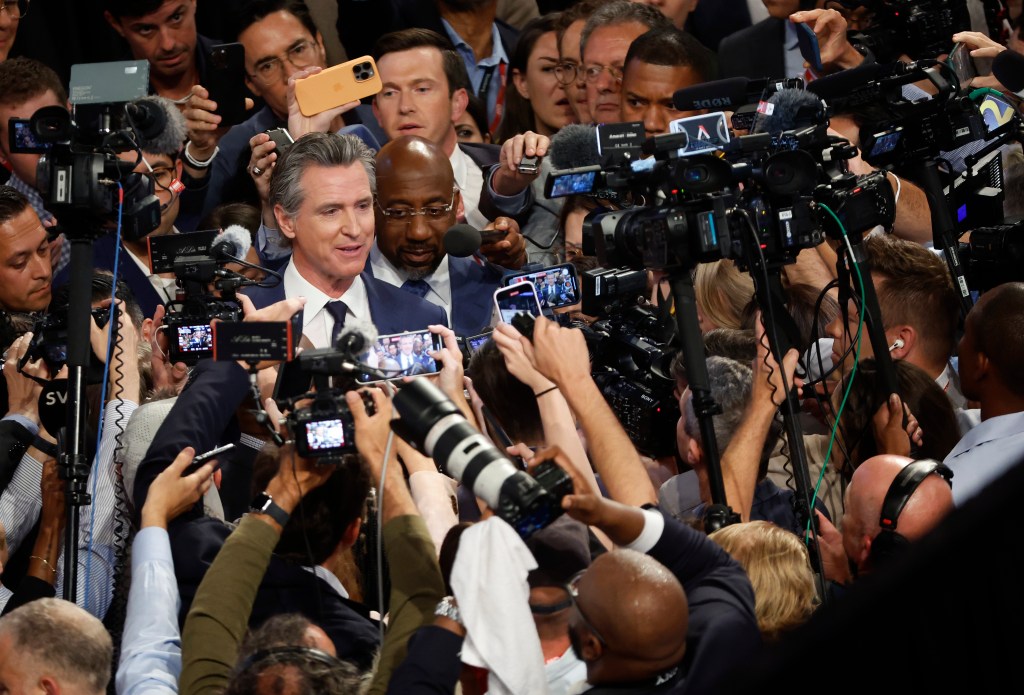 Gov. Gavin Newsom (D-CA) and Sen. Raphael Warnock (D-GA) speak to reporters in the spin room following the CNN Presidential Debate between U.S. President Joe Biden and Republican presidential candidate, former U.S. President Donald Trump at the McCamish Pavilion on the Georgia Institute of Technology campus on June 27, 2024.