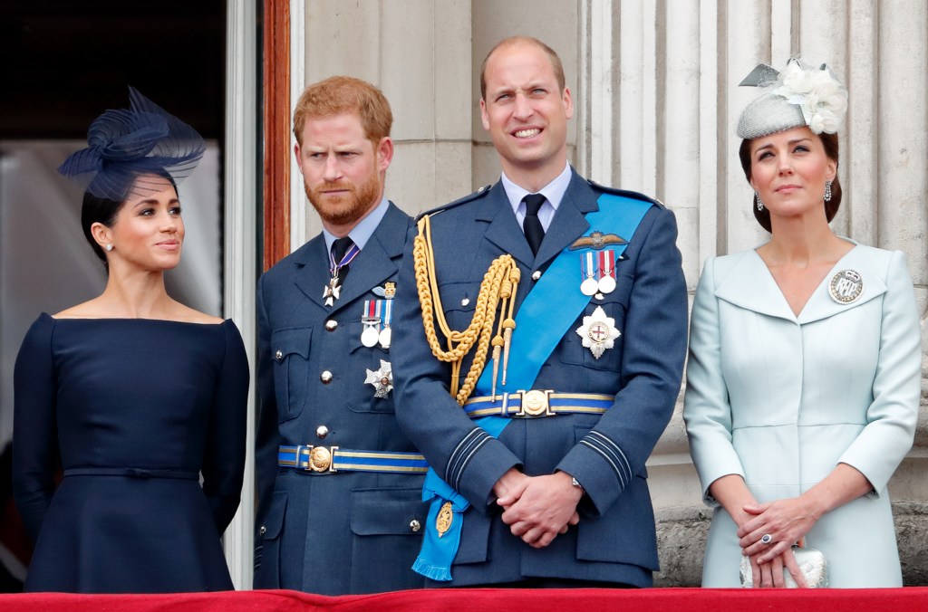 Members of the Royal Family including Prince William, Prince Harry, and Meghan, Duchess of Sussex, observing a flypast from the balcony of Buckingham Palace to mark the centenary of the RAF.