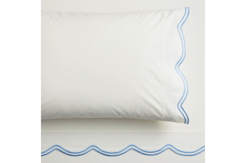 A white pillow with blue trim