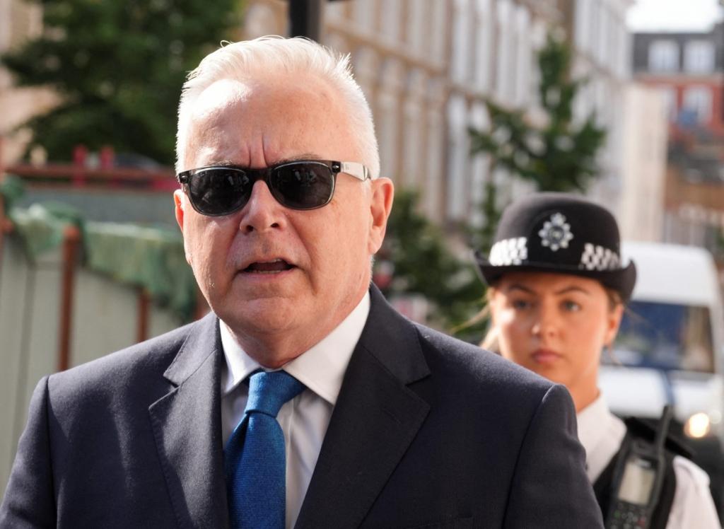 Huw Edwards, former BBC news presenter in suit and tie, walking outside Westminster Magistrates' Court in London.