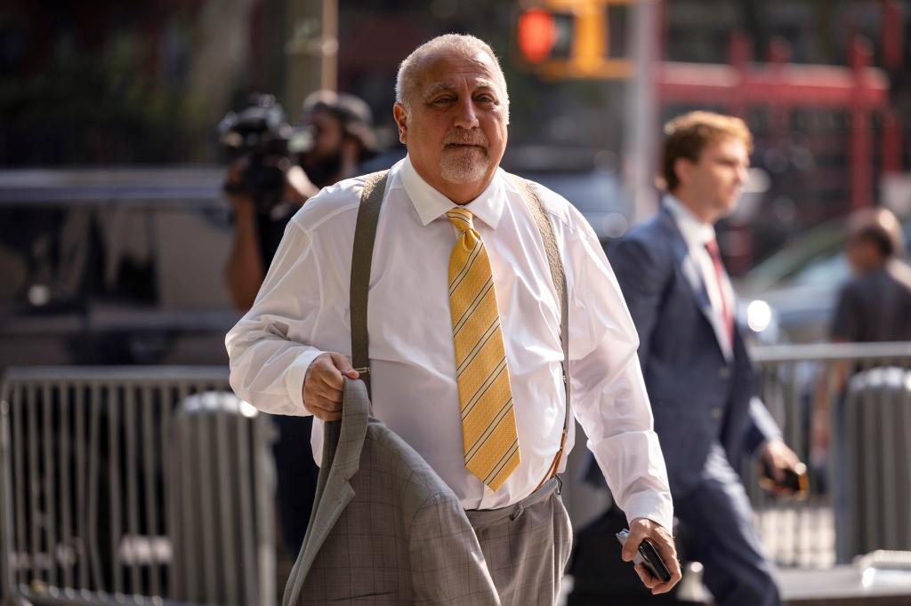 New Jersey businessman Fred Daibes holds his suit jacket outside federal court in Manhattan.