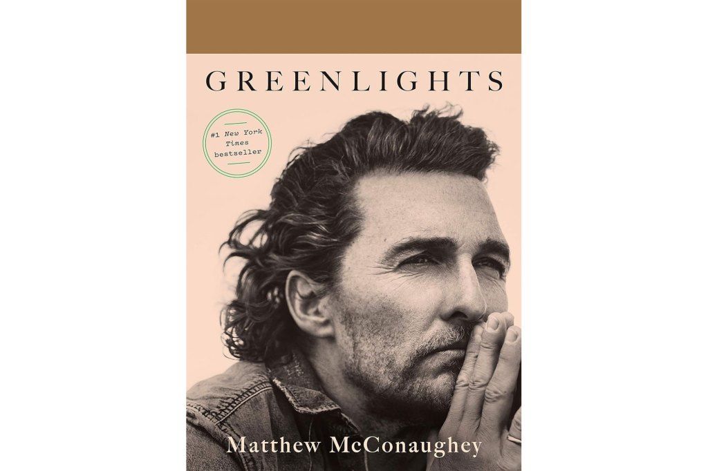 Matthew McConaughey with his hand on his face under green lights