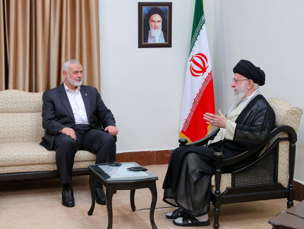 A handout picture provided by the office of Iran's Supreme Leader Ayatollah Ali Khamenei shows him (R) meeting with Hamas leader Ismail Haniyeh in Tehran on July 30, 2024.