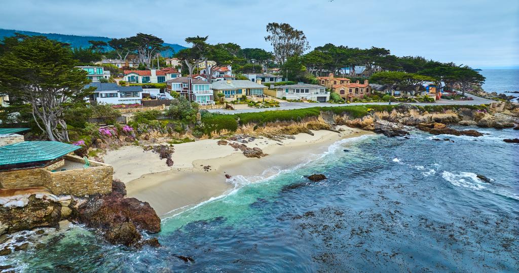 Image of Aerial with edge of Clinton Walker House by Frank Lloyd Wright and Carmel Beach with houses