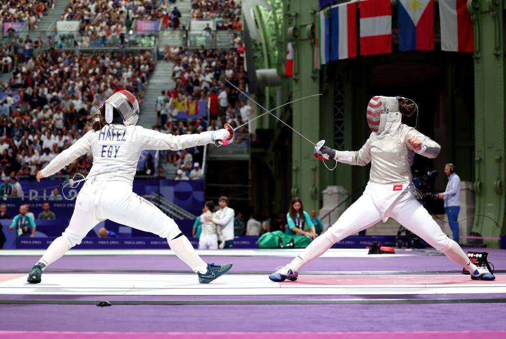  Nada Hafez of Team Egypt (L) and Elizabeth Tartakovsky of Team United States (R) compete in the Fencing Women's Sabre Individual Table of 32 on day three of the Olympic Games Paris 2024 at Grand Palais on July 29, 2024 in Paris, France. 