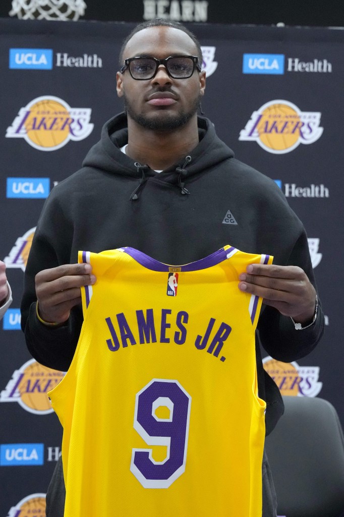 Bronny holds his new No. 9 jersey.