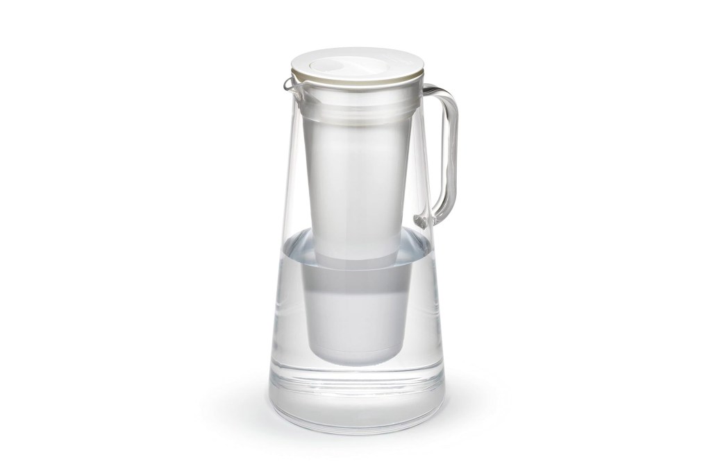 A water pitcher with a white cup and a clear container