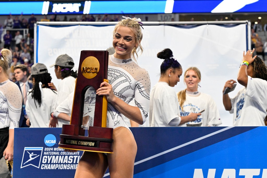 LSU Tigers gymnast Olivia Dunne poses with the trophy after the LSU Tigers gymnastics team wins the national championship in the 2024 Womens National Gymnastics Championship at Dickies Arena on April 20, 2024. 